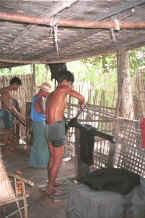 Jpeg 45K Straightening the threads and wringing out the water from the dyed cotton thread after it has been rinsed to stiffen and separate the threads - Amarapura, Shan State 9809e36.jpg