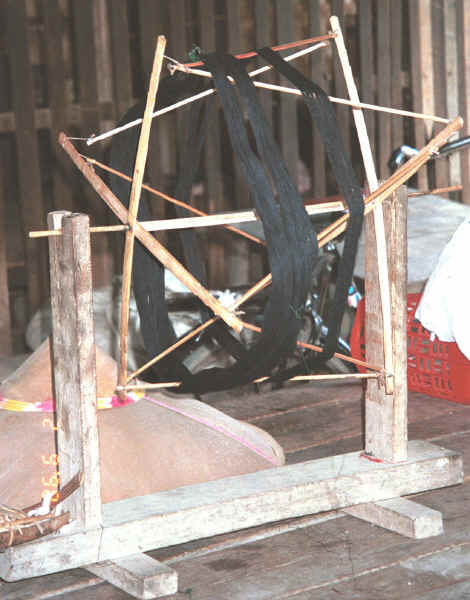 Indigo thread ready for being wound from the hank onto spools for weaving in a house in Amarapura, Shan State 9809f03.jpg