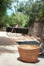 Jpeg 45K Hanks of dyed cotton hanging out to dry with charcoal, a bi-product of the dyeing process spread out in front to dry  - Amarapura, Shan State 9809f16.jpg