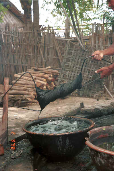 Wringing out the dyed hanks of cotton - Amarapura, Shan State 9809f30.jpg