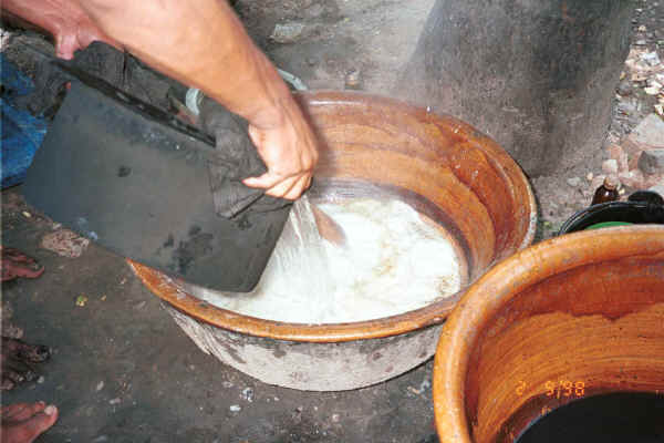 Further diluting the sago, oil and water rinse for the dyed cotton - Amarapura, Shan State 9809g08.jpg