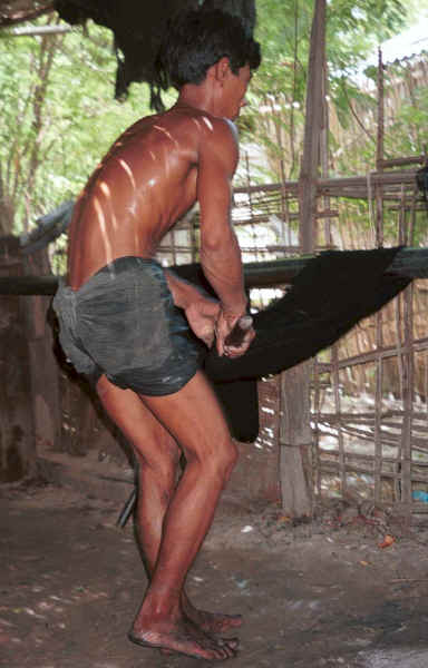 Straightening the threads and wringing out the water from the dyed cotton thread after it has been rinsed to stiffen and separate the threads - Amarapura, Shan State 9809g13.jpg