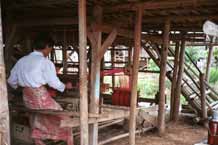 to Jpeg 52 K 9809R02 Weaving Shan bags under a house off a waterway at the back of the floating market at Ywa-ma- Lake Inle, Shan State.