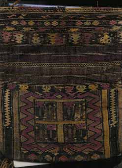 to Jpeg 49K A detail of a bag in the collection of Bill Hornaday. He describes the main body of the bag as densely woven silk. The braided strap is cotton. He believes that most of the dyes are vegetable, except for some very faded methl violet. He is pretty confident that the reds are lac or madder but that the pink accents are faded chemically died silk.