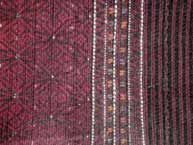 to Jpeg 54K Khumi woman's tubeskirt -detail showing the black warp and red, white and black supplementary weft patterning