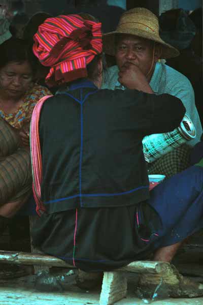 19K Jpeg 9809M34 Pa'O woman having a cup of tea in the 5-day rotating market in Kalaw, Shan State. The decoration on the seaming of her jacket and blouse shows up well.