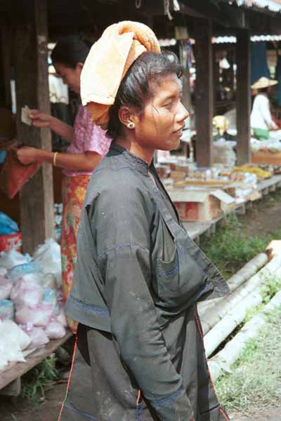 27K Jpeg 9809N21  Pa'O woman at Nampan 5-day rotating market, Lake Inle, Shan State. Note her short jacket with front pocket over her loose blouse with embroidery edging down the seams and her towelling headdress.