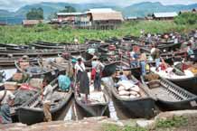 to 46K Jpeg 9809O02 Boats drawn up at the water's edge for the 5 - day rotating market at Nampan on Lake Inle, Shan State.