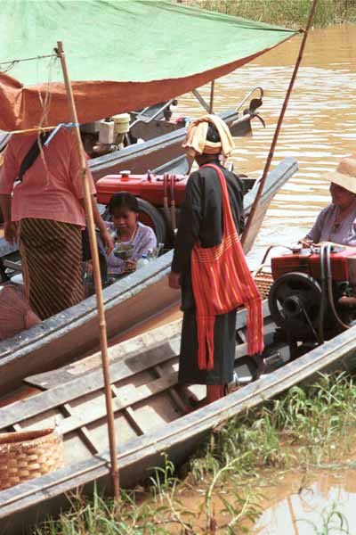 37K Jpeg 9809R35 Pa'O woman buying liquid fuel from a trader on one of the boats at Ywama floating market, Lake Inle, Shan State