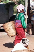 to 72K Jpeg Silver Palaung woman with a bask on her back striding through the market in Kalaw, Shan State