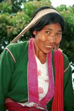 to 74K Jpeg Silver Palaung woman carrying the weight of a heavy basket on her head in the hills near to Kalaw. It is interesting to note that she has used a deep pink satin brocade for the wide edging around the front and neck of her blouse.