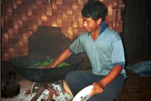 to 60K Jpeg Lightly heating the tea leaves in some water over the wood fire in Pein Ne Bin village, a Silver Palaung village, near Kalaw in southwestern Shan State. The Silver Palaung are famous for their 'pickled tea'.