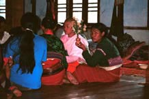 to 66K Jpeg Silver Palaung women gathering together to pray in the Buddhist temple in the centre of Pein Ne Bin village near Kalaw, northwestern Shan State on 'Full Moon Day' after the night of the full moon. Note the two women in traditional woven skirts, decorated bloues and the woman on the left of centre wearing bamboo or rattan hoops around her waist.