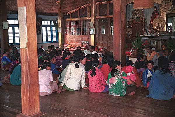 78K Jpeg Silver Palaung gathering together to pray in the Buddhist temple in the centre of Pein Ne Bin village near Kalaw, northwestern Shan State on 'Full Moon Day' after the night of the full moon. Most of the women are not wearing traditional dress although there are a few women who are doing so.