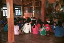 to 78K Jpeg Silver Palaung gathering together to pray in the Buddhist temple in the centre of Pein Ne Bin village near Kalaw, northwestern Shan State on 'Full Moon Day' after the night of the full moon. Most of the women are not wearing traditional dress although there are a few women who are doing so.