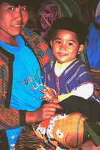 to 75K Jpeg Mother and small boy at the 'Full Moon day' prayers in the Buddhist temple in the Silver Palaung Pein Ne Bin village near Kalaw, southwestern Shan State.