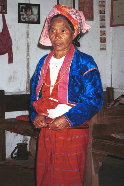 62K Jpeg Silver Palaung woman in traditional dress in Pein Ne Bin village near Kalaw, southwestern Shan State. Note that she is wearing two blouses (or salow) over what looks like a cotton tee-shirt. You can just see her bamboo or rattan hoops around her waist which seem to be fastened together by white metal clasps.