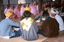 to 68K Jpeg The communal meal on the 'Full Moon day' festival in the Silver Palaung village of Pein Ne Bin, near Kalaw, southwestern Shan State - the monks and the men of the village. The men in the foreground are probably some of the senior men of the village. The monks are seen eating in the background.