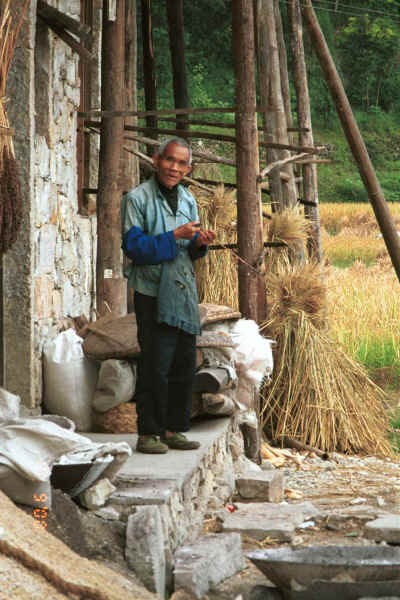 Bouyei old man with his pipe outside his house in Bi Ke village, Mi Gu township, Zhenfeng county, Guizhou province 0010s11.jpg