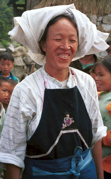 Bouyei woman against a background of school children - Bi Ke village, Mi Gu township, Zhenfeng county, Guizhou province 0010s15.jpg