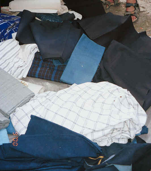 A tumble of Bouyei hand-woven and hand-dyed fabrics laid out for sale - Bi Ke village, Mi Gu township, Zhenfeng county, Guizhou province 0010s19.jpg