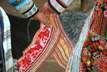 Jpeg 58K Miao women comparing their skirts - the black skirt on the left is hemp and the one on the right is ramie - Chang Tion village, Cheng Guan township, Puding county, Guizhou province 0010w17.jpg