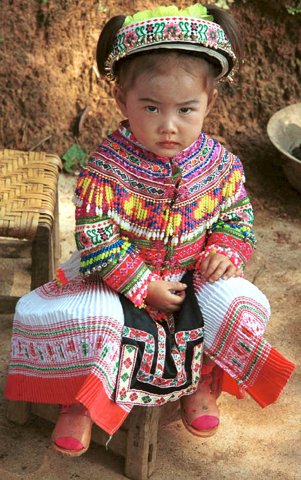 Little girl all dressed up in her festival finery although she was too young to dance - Da Shu Jia village, Xin Zhou township, Longlin county, Guangxi province 0010i04.jpg