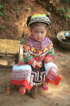 Jpeg 104K Little girl all dressed up in her festival finery although she was too young to dance - Da Shu Jia village, Xin Zhou township, Longlin county, Guangxi province 0010i04.jpg