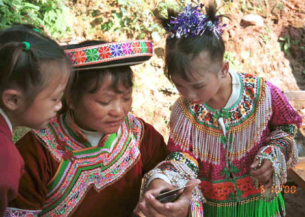 Examining the Polaroid instant photo of themselves - Da Shu Jia village, Xin Zhou township, Longlin county, Guangxi province 0010i09.jpg