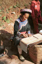 Jpeg 80K Clean Water Miao old lady examining her fine batik - Da Shu Jia village, Xin Zhou township, Longlin county, Guangxi province 0010i12.jpg