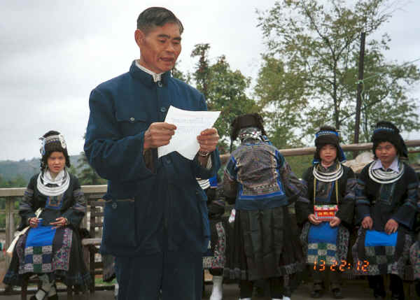 The village Secretary reading out a welcome and thanks to the Black Miao girls for dancing for us -  - Dai Lo village, Shi Zi township, Ping Ba county, Guizhou county 0010z19.jpg