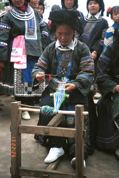 Black Miao woman demonstrating weaving braids - Dai Lo village, Shi Zi township, Ping Ba county, Guizhou county 0010z24.jpg