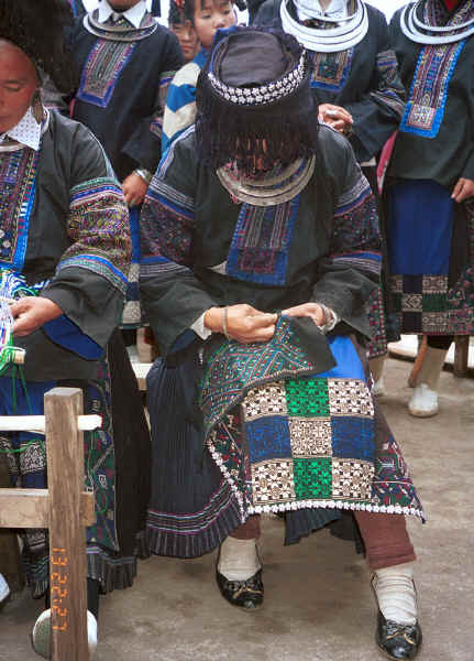 Black Miao girl demonstrating her embroidery on a piece for a woman's jacket - Dai Lo village, Shi Zi township, Ping Ba county, Guizhou county0010z25.jpg