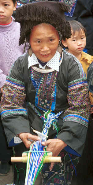 Black Miao woman demonstrating weaving a braid - Dai Lo village, Shi Zi township, Ping Ba county, Guizhou county 0010z28.jpg