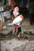 Jpeg 30K Back view of a Flower Miao woman at De Wo market, De Wo township, Longlin county, Guangxi province 0010f24.jpg