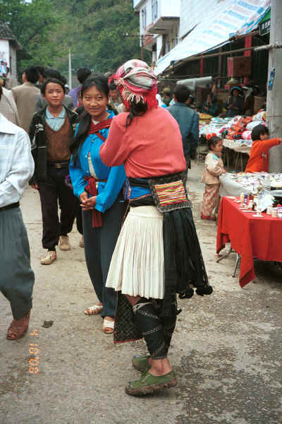 White Miao woman meeting a friend in De Wo market, De Wo township, Longlin county, Guangxi province 0010f33.jpg