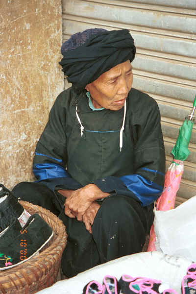 Selling handmade shoes at De Wo market.  Possibly a Bouyei old lady.  De Wo township, Longlin county, Guangxi province 0010g22.jpg