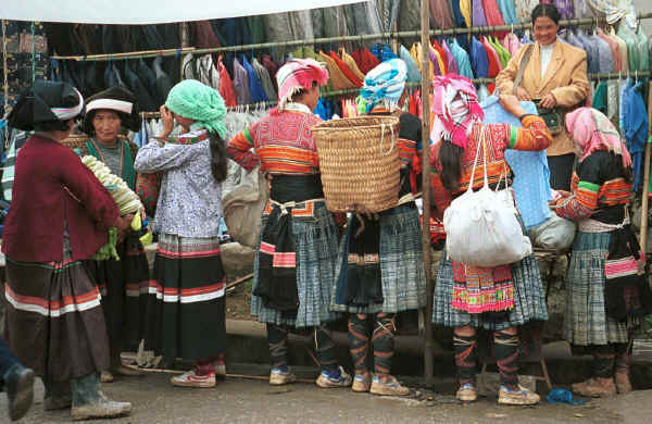 Side comb Miao and Flower Miao women buying modern clothes at De Wo market, De Wo township, Longlin county, Guangxi province 0010g26A.jpg