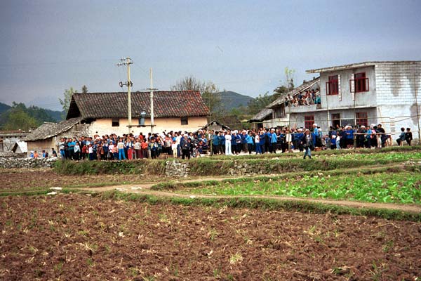 Jpeg 57K  0110E25 Villagers gathered together for our visit in Gan He village, Ya Rong township, Huishui county, Guizhou province, south-west China. The people living in this village are known as Qing Miao. There has been much intermarriage between Miao and Bouyei which is evident from the costume of the women. 