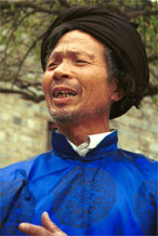 to Jpeg 106K Head man of Gao Zhai village, Bai Jin township, Huishui county, Guizhou province welcoming us to the village having put on a splendid silk coat over his working clothes 0110C11