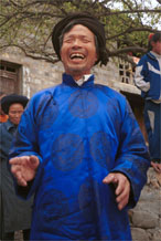 to Jpeg 139K Head man of Gao Zhai village, Bai Jin township, Huishui county, Guizhou province welcoming us to the village having put on a splendid silk coat over his working clothes 0110C12