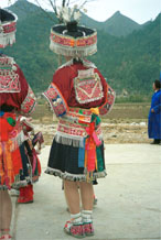 to Jpeg 158K Back view of Iron beating Miao women's costume in Gao Zhai village, Bai Jin township, Huishui county, Guizhou province against the backdrop of the farm land and mountains rising from the narrow valley 0110C17