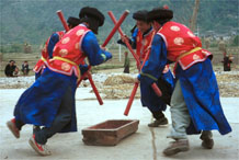 to Jpeg 78K Miao men dancing and simulating stirring sticky rice in Gao Zhai village, Bai Jin township, Huishui county, Guizhou province against the backdrop of the farm land in the narrow valley 0110C26