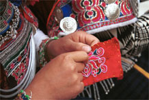 to Jpeg 104K Iron beating Miao women in Gao Zhai village, Bai Jin township, Huishui county, Guizhou province working on some embroidery and wearing their festival costume 0110C29