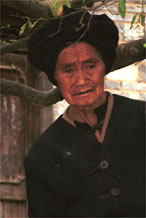 to Jpeg 75K Elderly Iron beating Miao woman watching proceedings in Gao Zhai village, Bai Jin township, Huishui county, Guizhou province 0110C35