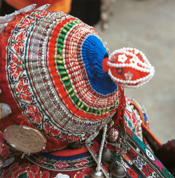 Jpeg 129K Iron beating Miao girl's hat, Gao Zhai village, Bai Jin township, Huishui county, Guizhou province showing some hand woven braid streamers from the nape of the bonnet 0110C37