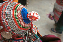 to Jpeg 129K Iron beating Miao girl's hat, Gao Zhai village, Bai Jin township, Huishui county, Guizhou province showing some hand woven braid streamers from the nape of the bonnet 0110C37