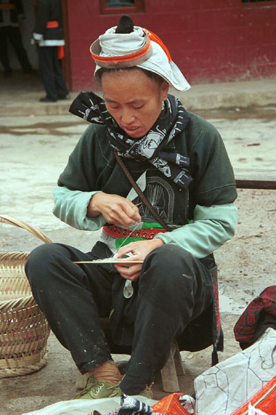 Jpeg 59K 0111G34 Gejia women working on needle knitting the small net which is used to enclose the Gejia women's hair buns - a key part of their identifying headdress still being worn currently even when much of the rest of the costume has been exchange for western clothing. Ma Tang village, Kaili City, Guizhou province.