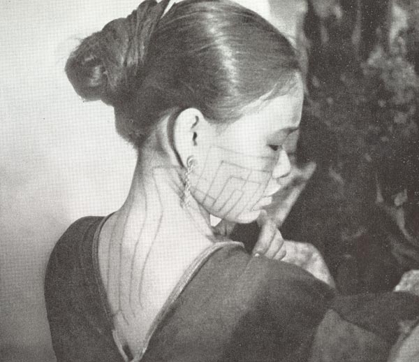 Jpeg 52K A Ba-sa-dung woman showing her tattoos on face and the back of her neck from the article in the September 1938 National Geographic by Leonard Clark telling of his 5-week trek into the interior of Hainan in the summer of 1937.