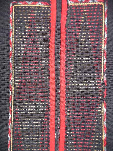 Jpeg 64K Detail of the embroidered front opening of a Qi Li woman's embroidered blouse purchased in 2005 in in the style of those from Changjiang in Hainan Island